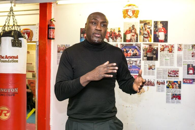 Derek speaking to a group in a boxing gym
